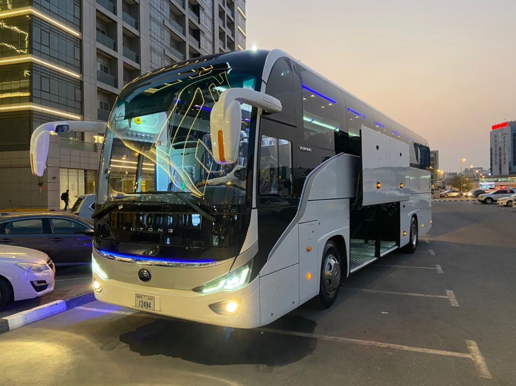 A prominent white bus parked, highlighting luxury Luxury bus transport services in Dubai.